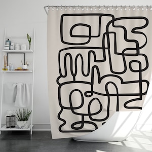 May include: A beige shower curtain featuring a black abstract design of lines and shapes. The design is reminiscent of a maze or a city skyline.