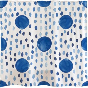May include: White shower curtain with a blue watercolor polka dot pattern. The dots are of varying sizes and are arranged in a random pattern.