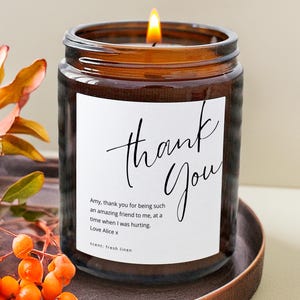 Personalised thank you candle in amber glass jar with custom message label, gratitude gift idea