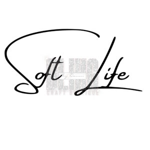 May include: Black and white cursive text that reads "Soft Life" with a decorative flourish.