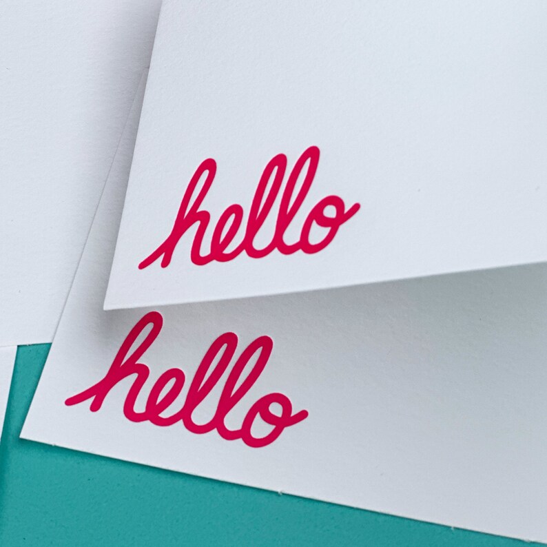 Two Letterpress Cards with the word hello printed in the bottom left corner.