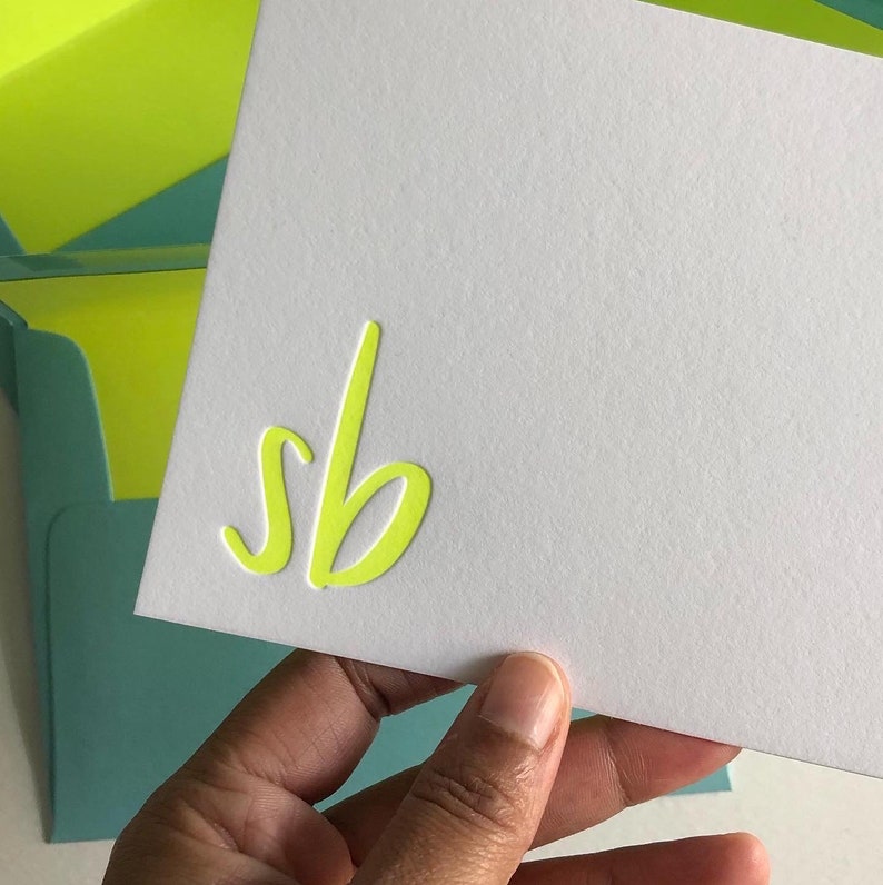 A hand holding a notecard as a Letterpress Stationery gift