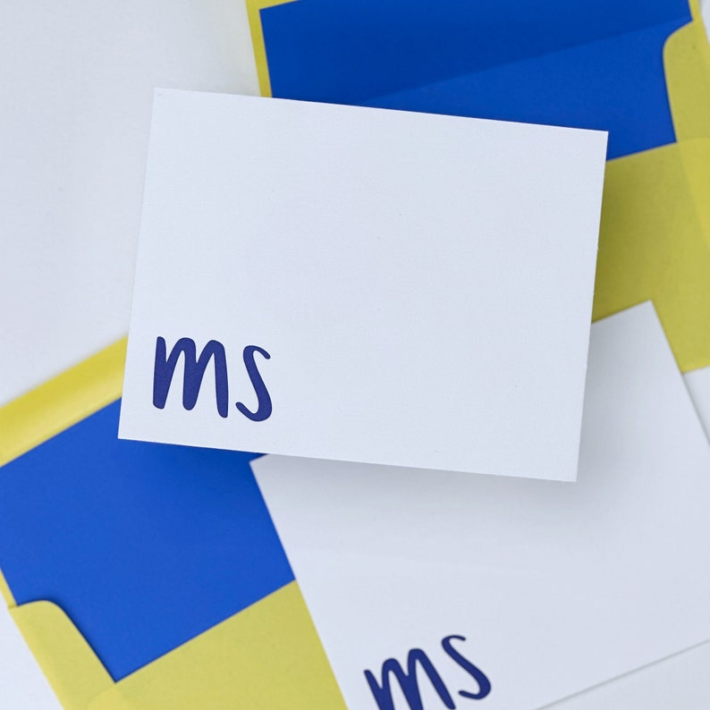 Custom Stationery with the initials m and s and yellow envelopes with envelope liner