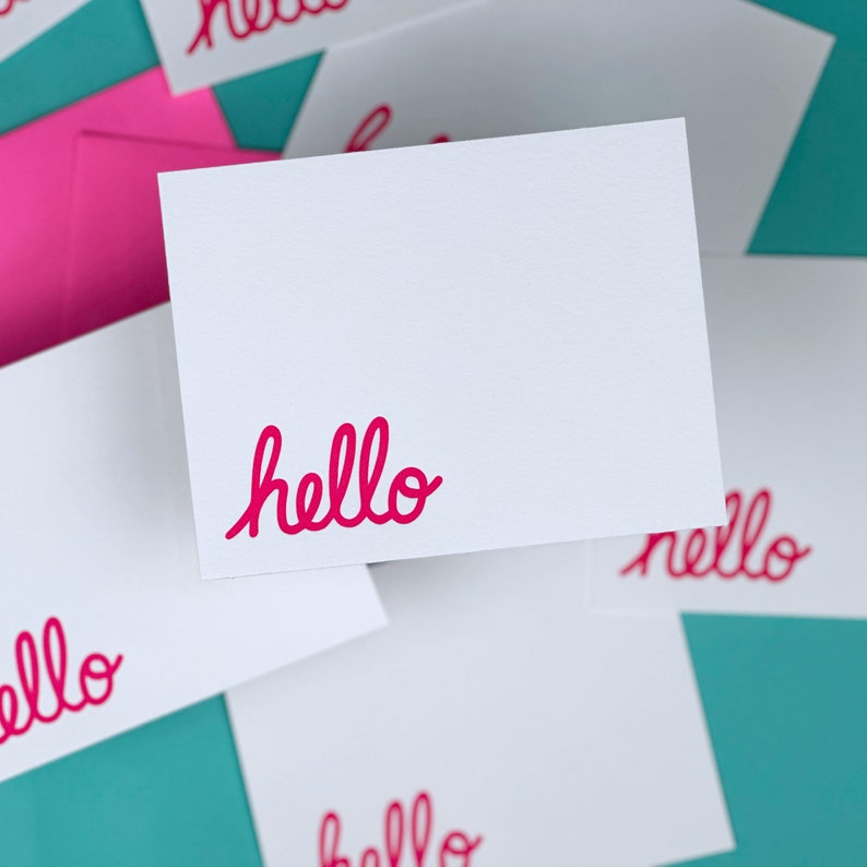 Calligraphy hello printed in the bottom left corner of flat cards.