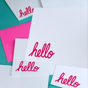 Letterpress printed stationery set with envelopes. The flat cars have the word hello printed in pink.