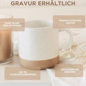 May include: A white ceramic mug with a speckled design and a tan base. The mug has a capacity of 12.17 fluid ounces and features the text "AUCH OHNE GRAVUR ERH&Auml;LTLICH". The mug is dishwasher safe and made of high-quality ceramic.