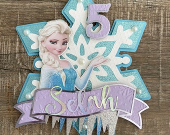 Frozen Queen Elsa Winter Wonderland Themed Birthday Cake Topper Set  Featuring Elsa and Decorative Themed Accessories : : Toys & Games