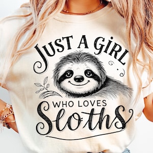 May include: A white t-shirt with a black graphic of a sloth and the text "Just a girl who loves sloths".