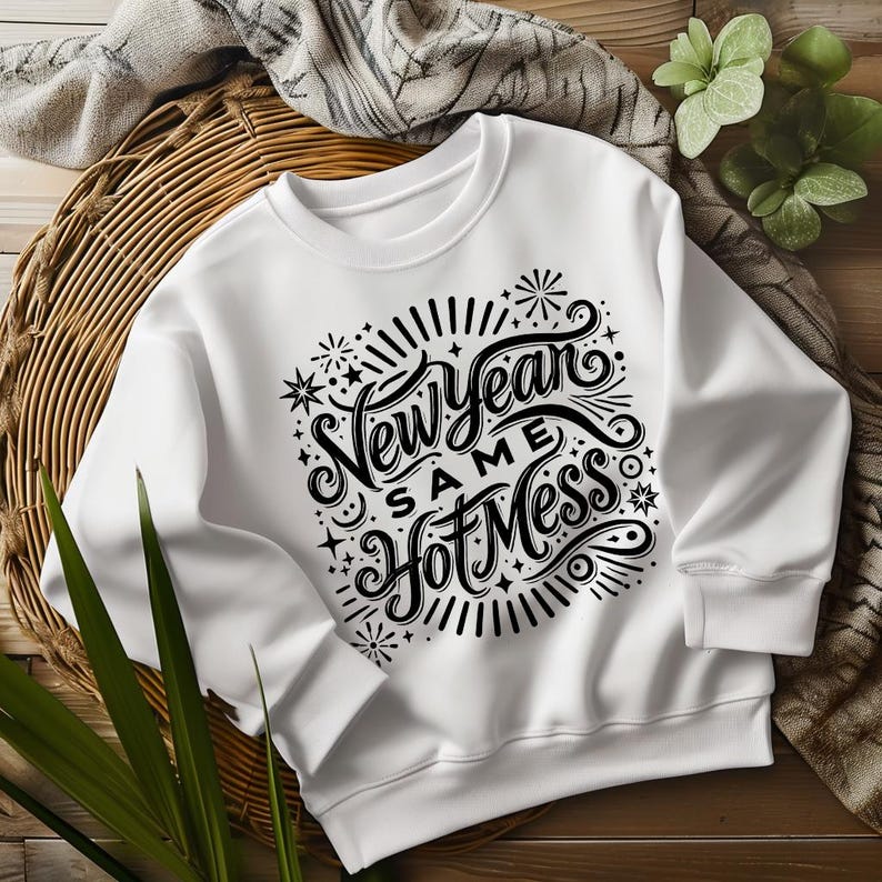 May include: White sweatshirt with a black graphic print that says "New Year Same Hot Mess" with stars and fireworks around the text.