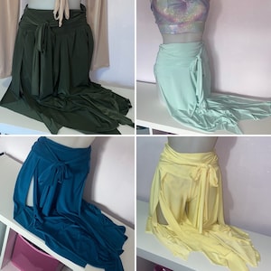May include: Four different styles of long skirts with slits on the sides. The skirts are in green, light blue, teal, and yellow.