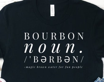 May include: Black t-shirt with white text that reads "BOURBON noun. /'BƏRBƏN/ -magic brown water for fun people"