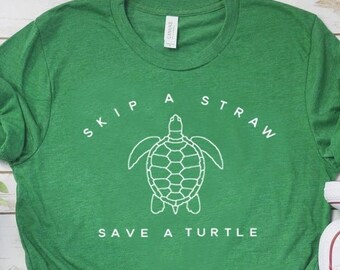 May include: Green t-shirt with a white outline of a sea turtle and the text "Skip a Straw Save a Turtle".