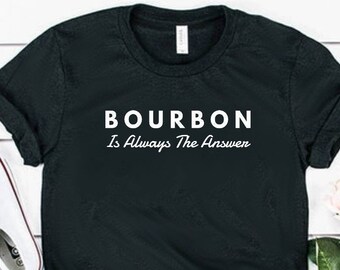 May include: Black t-shirt with white text that reads "BOURBON Is Always The Answer".