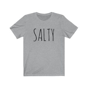 May include: A heather gray t-shirt with the word "SALTY" printed in black.