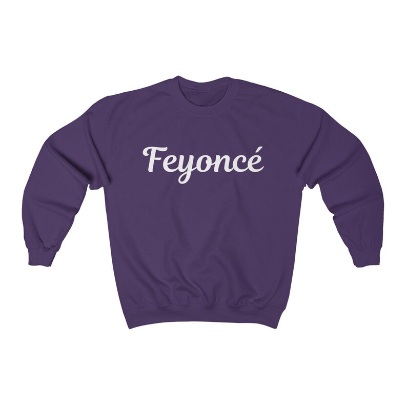 K&ouml;nnte beinhalten: Lilafarbener Pullover mit dem Wort "Feyonc&eacute;" in wei&szlig;er kursivschrift.