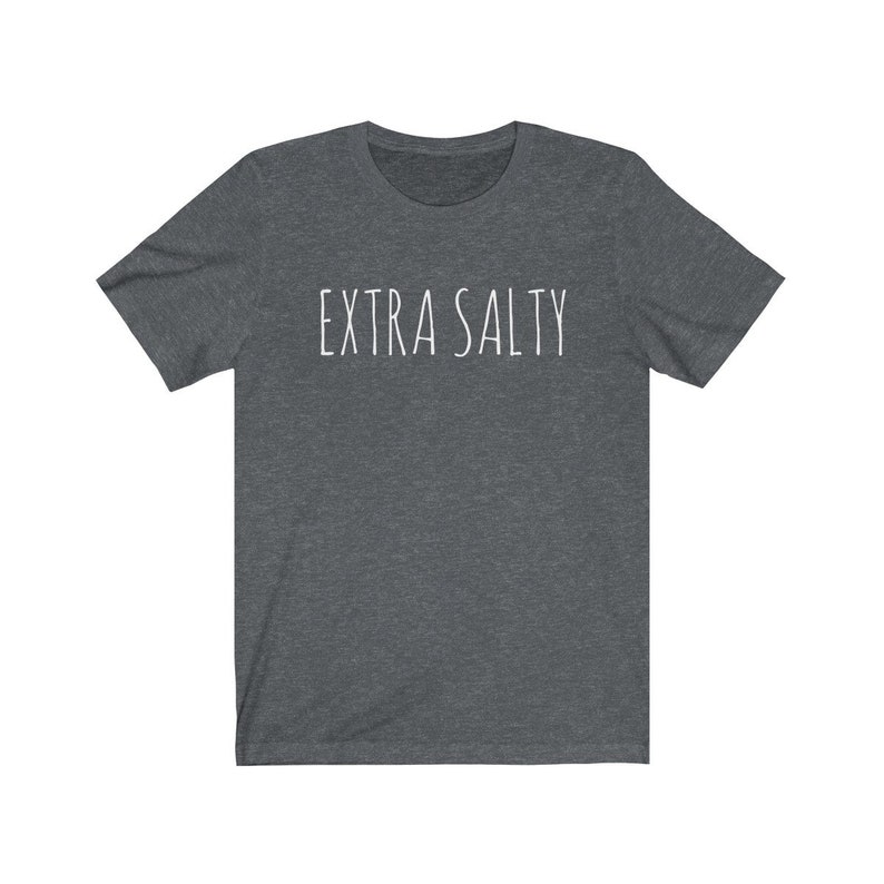 May include: A dark heather grey t-shirt with the text "EXTRA SALTY" printed in white.