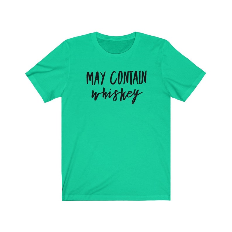 May include: A bright green t-shirt with the phrase "MAY CONTAIN whiskey" printed in black cursive lettering. The shirt has short sleeves and a crew neck.