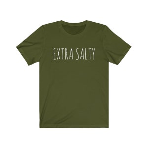 May include: A green short-sleeved t-shirt with the text "EXTRA SALTY" printed in white on the front.