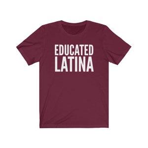 May include: Burgundy short-sleeved t-shirt with the text "EDUCATED LATINA" in white.