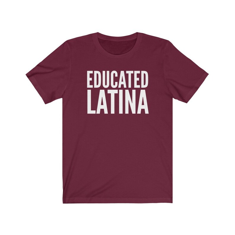 May include: Burgundy short-sleeved t-shirt with the text "EDUCATED LATINA" in white.