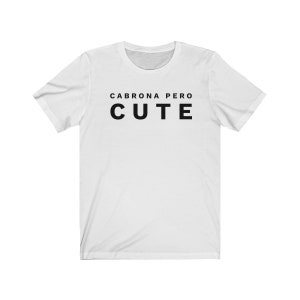 May include: White t-shirt with black text that reads "Cabrona pero cute".