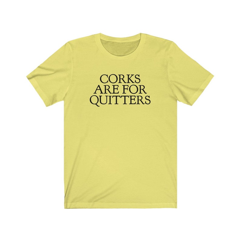 May include: A yellow t-shirt with the text "CORK ARE FOR QUITTERS" printed in black.