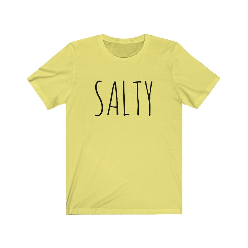 May include: A yellow short-sleeved t-shirt with the word "SALTY" printed in black on the front.