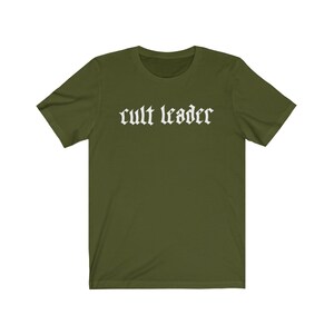May include: A green short-sleeved t-shirt with the text "cult leader" in white gothic lettering.