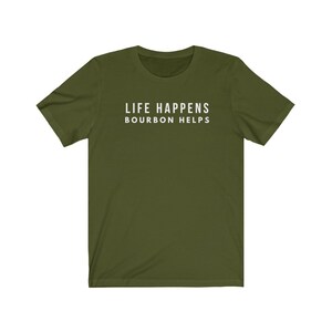 May include: A green short-sleeved t-shirt with the text "LIFE HAPPENS BOURBON HELPS" printed in white on the front.