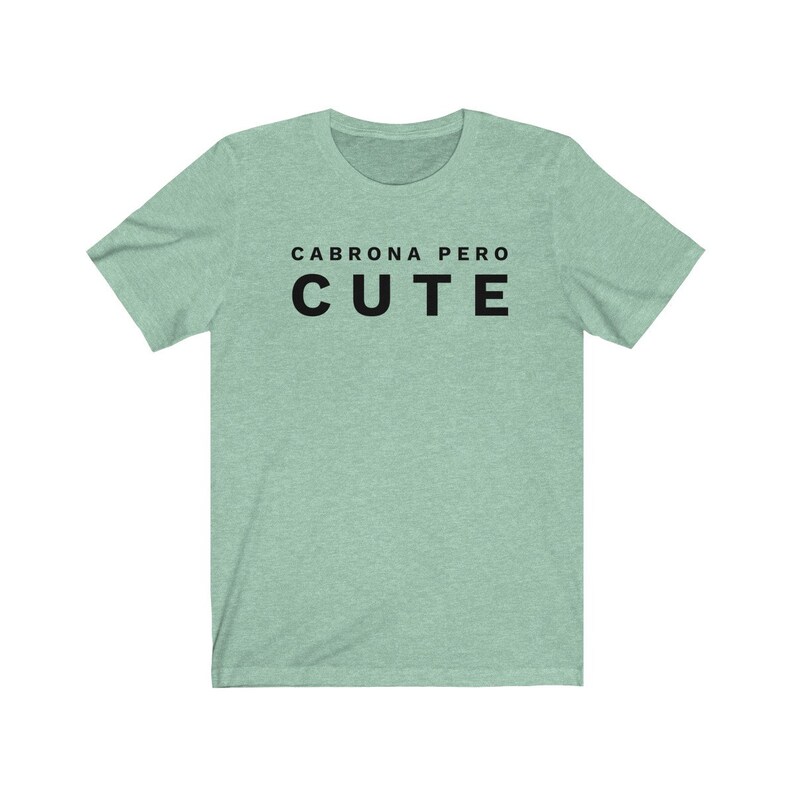 May include: A light green t-shirt with the text "Cabrona pero cute" in black.