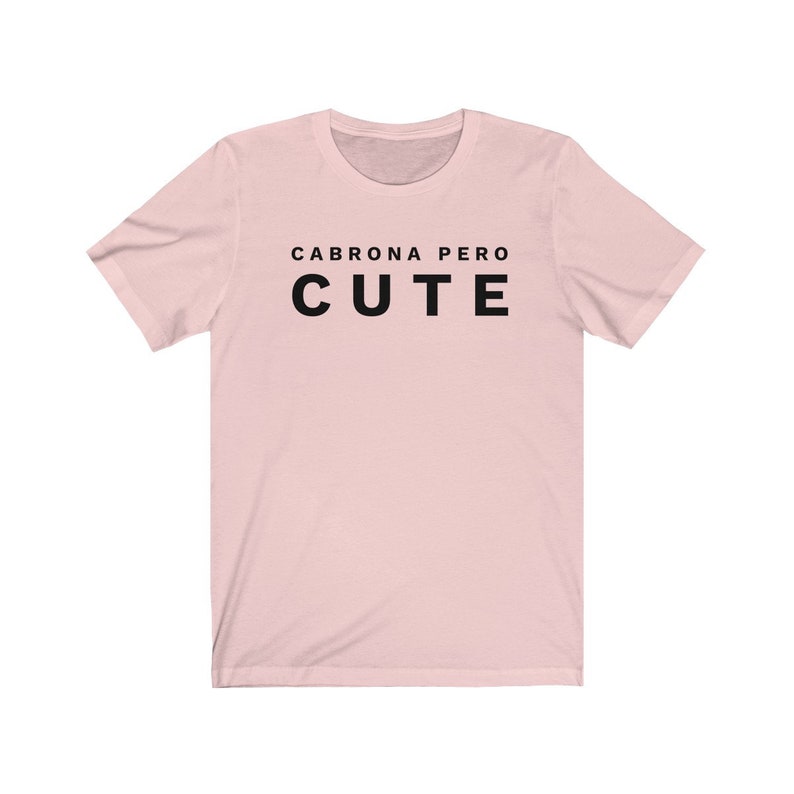 May include: A pink t-shirt with the text "Cabrona pero cute" in black.
