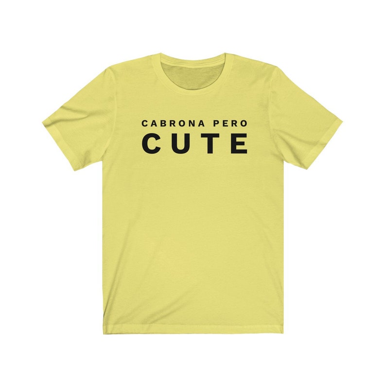 May include: A yellow t-shirt with black text that reads "Cabrona pero cute".