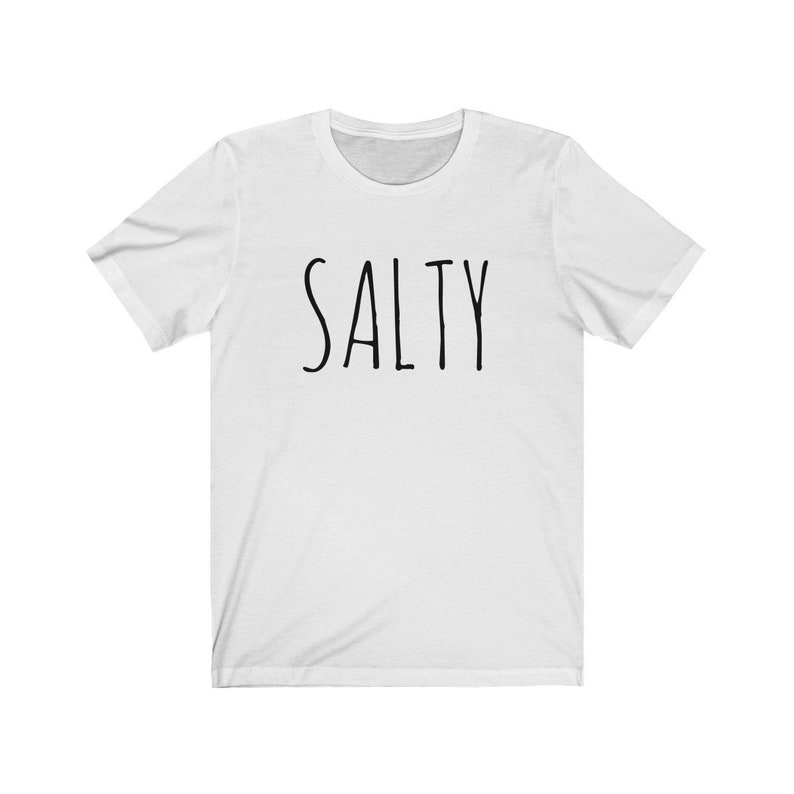 May include: White t-shirt with the word "SALTY" printed in black on the front.