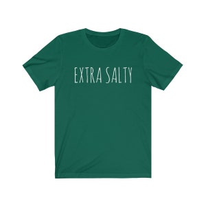 May include: A dark green t-shirt with the text "EXTRA SALTY" printed in white on the front.