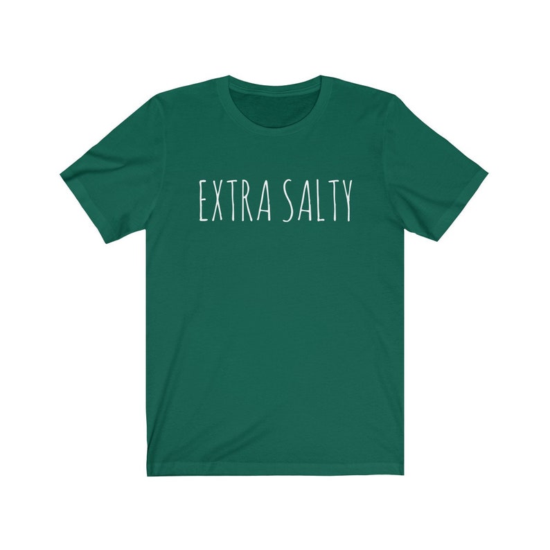 May include: A dark green t-shirt with the text "EXTRA SALTY" printed in white on the front.
