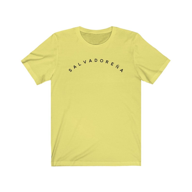 May include: A yellow short-sleeved t-shirt with black text that reads "SALVADORENA" in an arc.