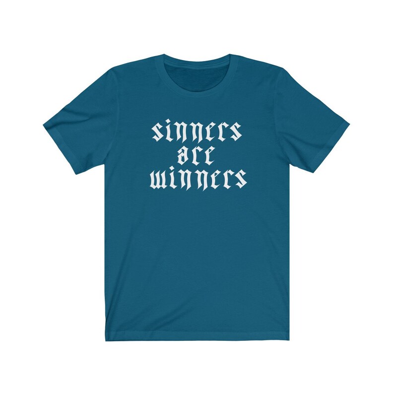 May include: A teal blue t-shirt with the text "sinners are winners" in white gothic font.