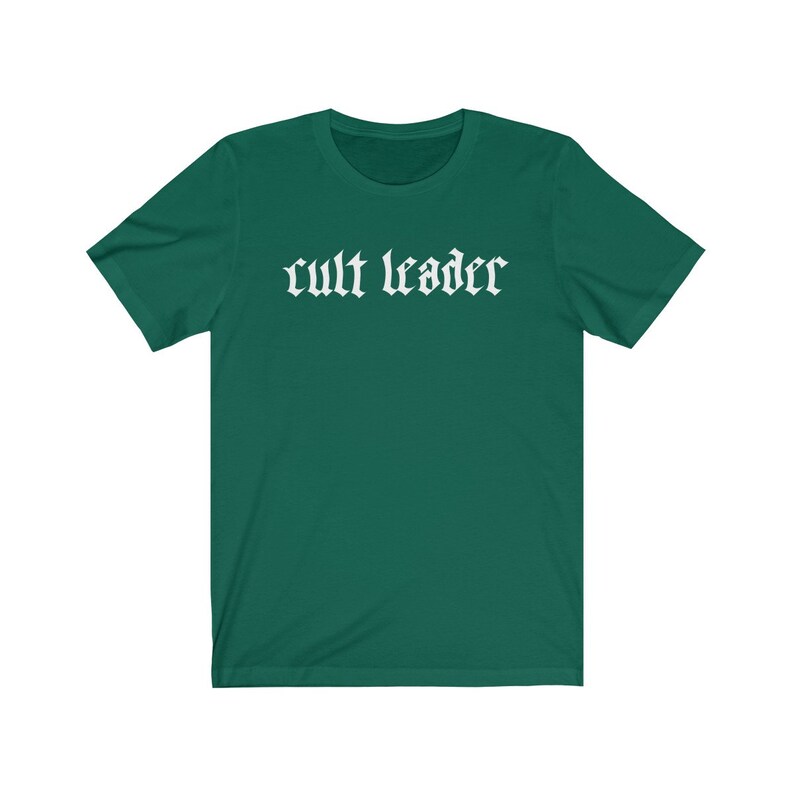May include: A dark green t-shirt with the text "cult leader" in white gothic font.