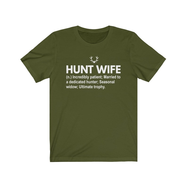 May include: A green t-shirt with a white print that reads "HUNT WIFE (n.) Incredibly patient; Married to a dedicated hunter; Seasonal widow; Ultimate trophy."