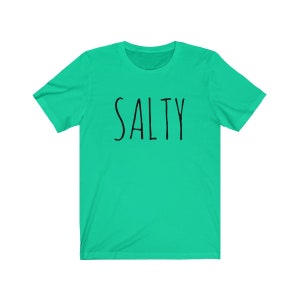 May include: A turquoise blue t-shirt with the word "SALTY" printed in black.