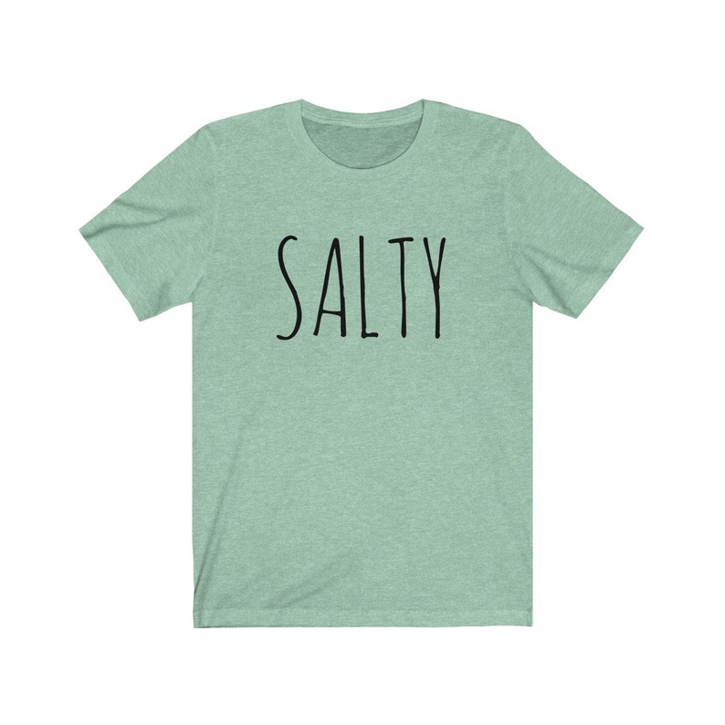 May include: A light green t-shirt with the word "SALTY" printed in black on the front.