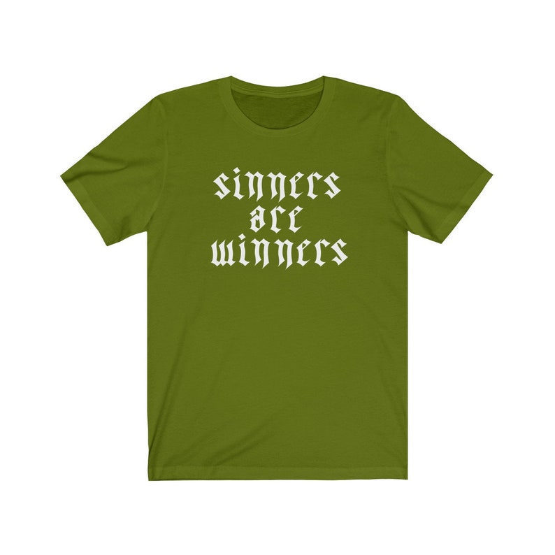 May include: A green t-shirt with the text "sinners are winners" in white gothic font.