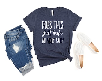 May include: A navy blue t-shirt with the text "Does this shirt make me look tall?" in white lettering.