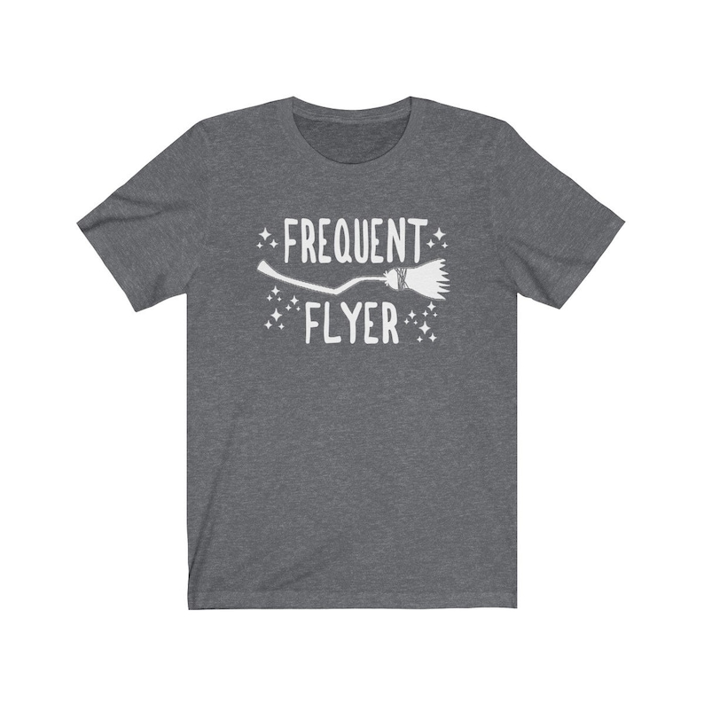 May include: A dark heather grey t-shirt with a white graphic of a broom and the text "Frequent Flyer".
