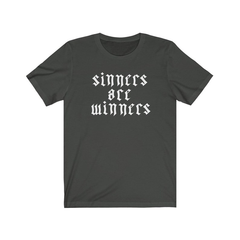May include: Dark gray t-shirt with white text that reads "sinners are winners" in a gothic font.