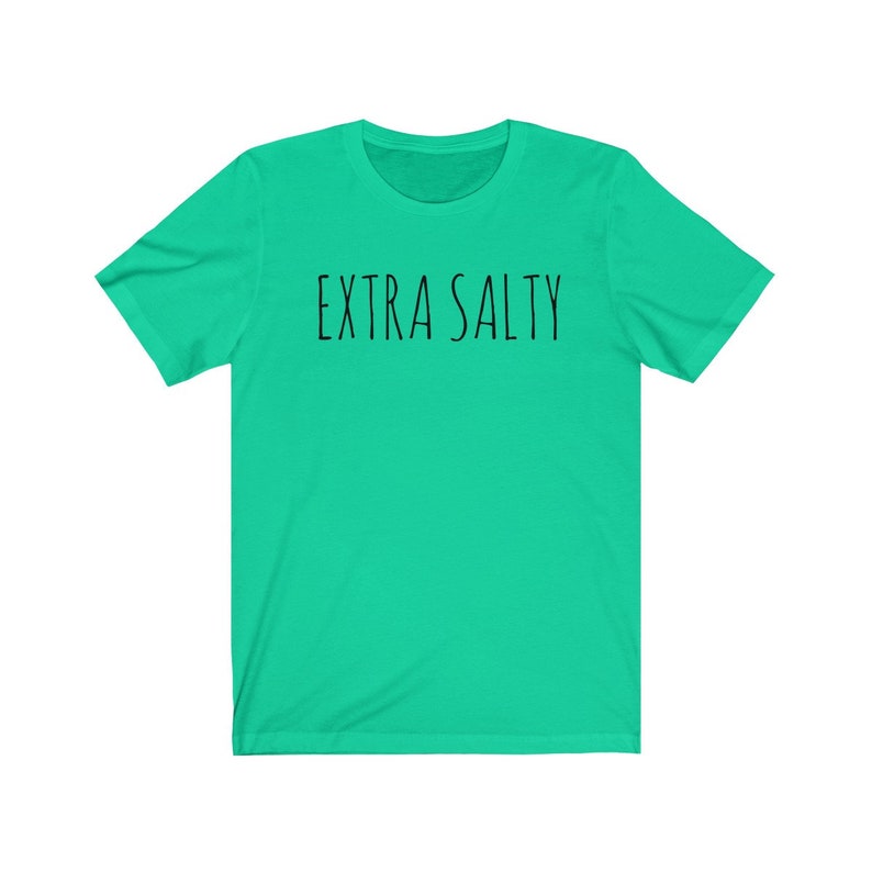 May include: A turquoise t-shirt with the text "EXTRA SALTY" printed in black.
