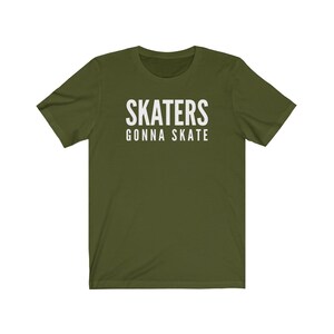 May include: A green short-sleeved t-shirt with the text "SKATERS GONNA SKATE" in white.