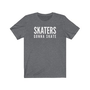 May include: A dark heather grey t-shirt with white text that reads "SKATERS GONNA SKATE".