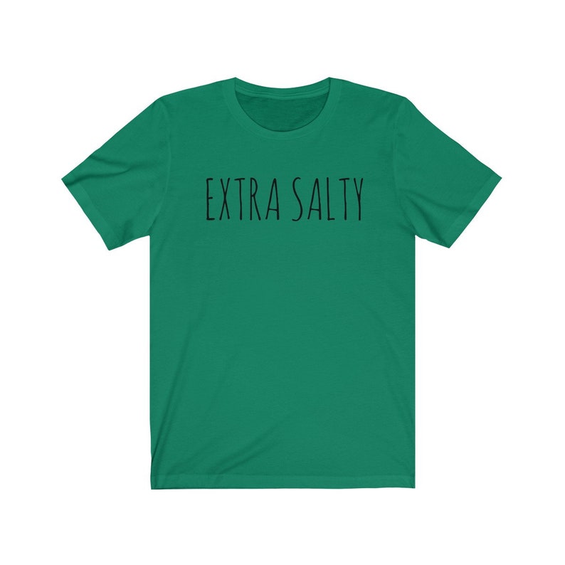 May include: A green short-sleeved t-shirt with the text "EXTRA SALTY" printed in black on the front.