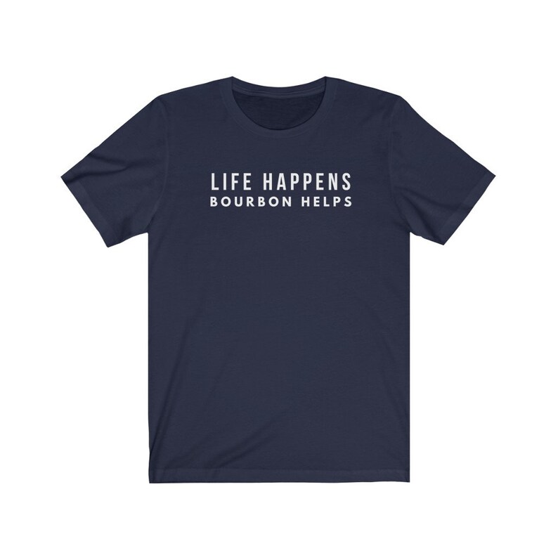 May include: A navy blue t-shirt with the text "LIFE HAPPENS BOURBON HELPS" printed in white on the front.